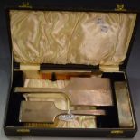 A four piece silver dressing table hand mirror and brush set, Birmingham 1938,