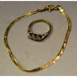 An 18ct gold bracelet; an illusion set three stone diamond ring, marks rubbed, 5.