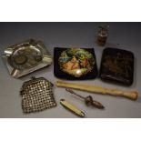 A silver ash tray; a Japanese cigarette case; a white metal bottle stopper,