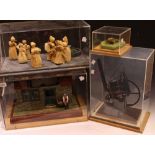 A scratch built model of a cobbler's shop, perspex cased; other cased models, Trevithick Engine,