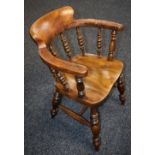A Victorian elm smoker's bow elbow chair, curved cresting rail, turned gallery and arm posts,