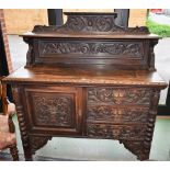 A Victorian oak sideboard, shelved half gallery crested by scrolling acanthus,