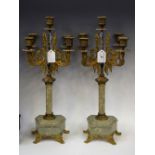 A pair of Rococo style gilt metal five branch candelabra/garnitures,