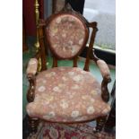 A Victorian mahogany open armchair, deep button oval back flanked by fluted foliate capped supports,