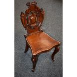 A Victorian mahogany hall chair, shaped back terminating in scrolls, moulded serpentine seat,