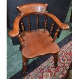 A Victorian elm smoker's bow elbow chair, bowed arm rail terminating in outswept hand rests,