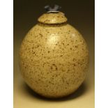 A stoneware ovoid vase and cover, by Helen Walters, speckled glazed in brown on an oatmeal ground,