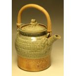 A salt glazed stoneware teapot, by Jane Hamlyn, in mottled shades of green and brown,