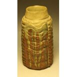 A stoneware cylindrical ribbed vase, by Bernard Rook, incised with stylised reptilian scales,