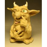 A stoneware doorstop, modelled as a comical grotesque horned goblin, 26cm high,