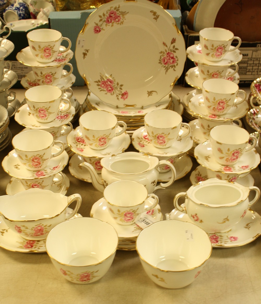 A Royal Crown Derby Pinxton Roses pattern tea and dinner service comprising nineteen cups,