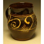 A Winchcombe Pottery earthenware slip glazed ovoid jug, by Sidney Tuskin,