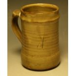 A Wenford Bridge ribbed cylindrical mug, by Danlami Aliyu, slip glazed in mottled olive green,