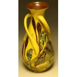 A C H Brannam Barum terracotta slender ovoid tyg vase, applied with three asymmetric loop handles,