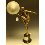 An Art Deco spelter table lamp, modelled as a scantily clad dancing girl in period dress,