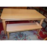 A contemporary Ercol dining table, rounded rectangular top above a deep frieze,
