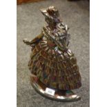 An early 20th century cast iron fire side companion set in the form of a maiden, chrome, with tongs,