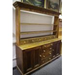 A large pine dresser, shelving over six short drawers to top,