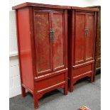 A pair of red oriental wardrobes,