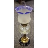 A Victorian oil lamp with brass column base, clear glass bowl,