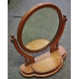 A Victorian mahogany oval dressing table mirror, with hinged compartment, 69cm x 59cm, c.