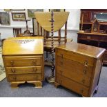 A 1940's oak bureau; an oak four drawer chest; an oak barley twist standard lamp;