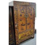 An oriental wardrobe carved with elders and fauna in relief