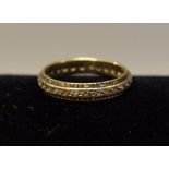 A gold coloured metal eternity ring