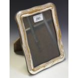 A Continental silver shaped rectangular easel photograph frame,