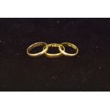 A 22ct gold ring (3.8g); an 18ct gold ring (2g); a 9ct ring (2.