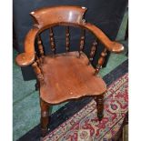 A Victorian elm smoker's bow elbow chair, bowed arm rail terminating in outswept hand rests,