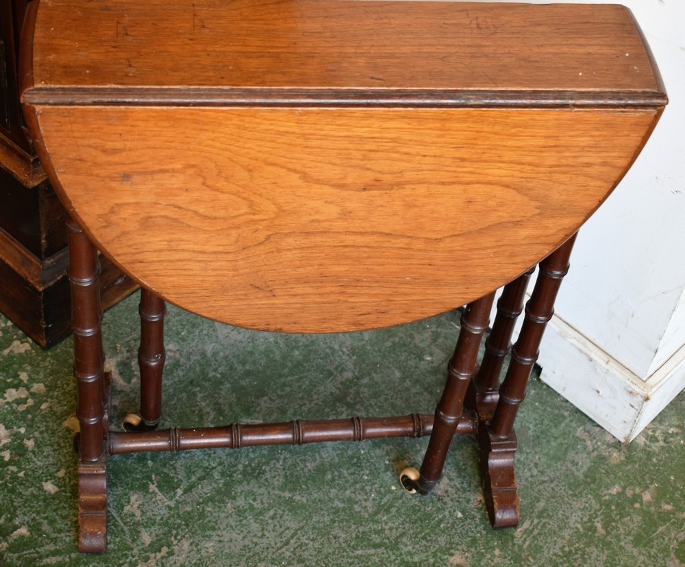 A late Victorian/Edwardian Sutherland table, of small proportions, eliptical top with fall leaves,