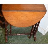 A late Victorian/Edwardian Sutherland table, of small proportions, eliptical top with fall leaves,