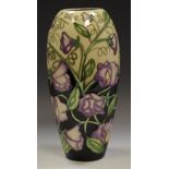 A contemporary Moorcroft vase, tube lined with purple flowers,