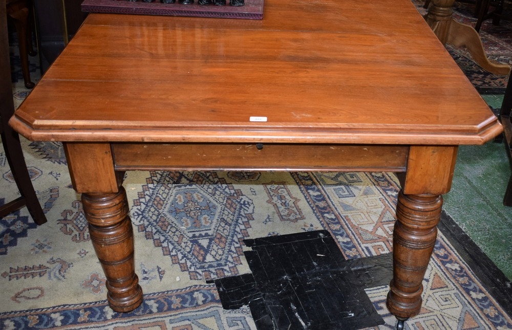 A Victorian mahogany wind out canted rectangular dining table, boldly turned supports, c.