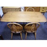 An Ercol trestle type dining table;