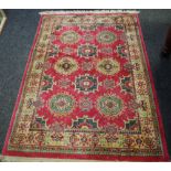 A Persian silk and wool carpet two rows of Elephant Foot guls on a claret ground cream floral