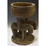 Tribal Art - an African offertory bowl with carved animal columns.