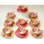Aynsley - a near set of nine gilded tea cups and saucers decorated with peonies,
