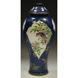 A Wedgwood slender inverted baluster vase and cover decorated with birds amongst flowering stems,