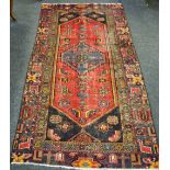 A Hamadan carpet, central geometric medallion, floral guard stripe,