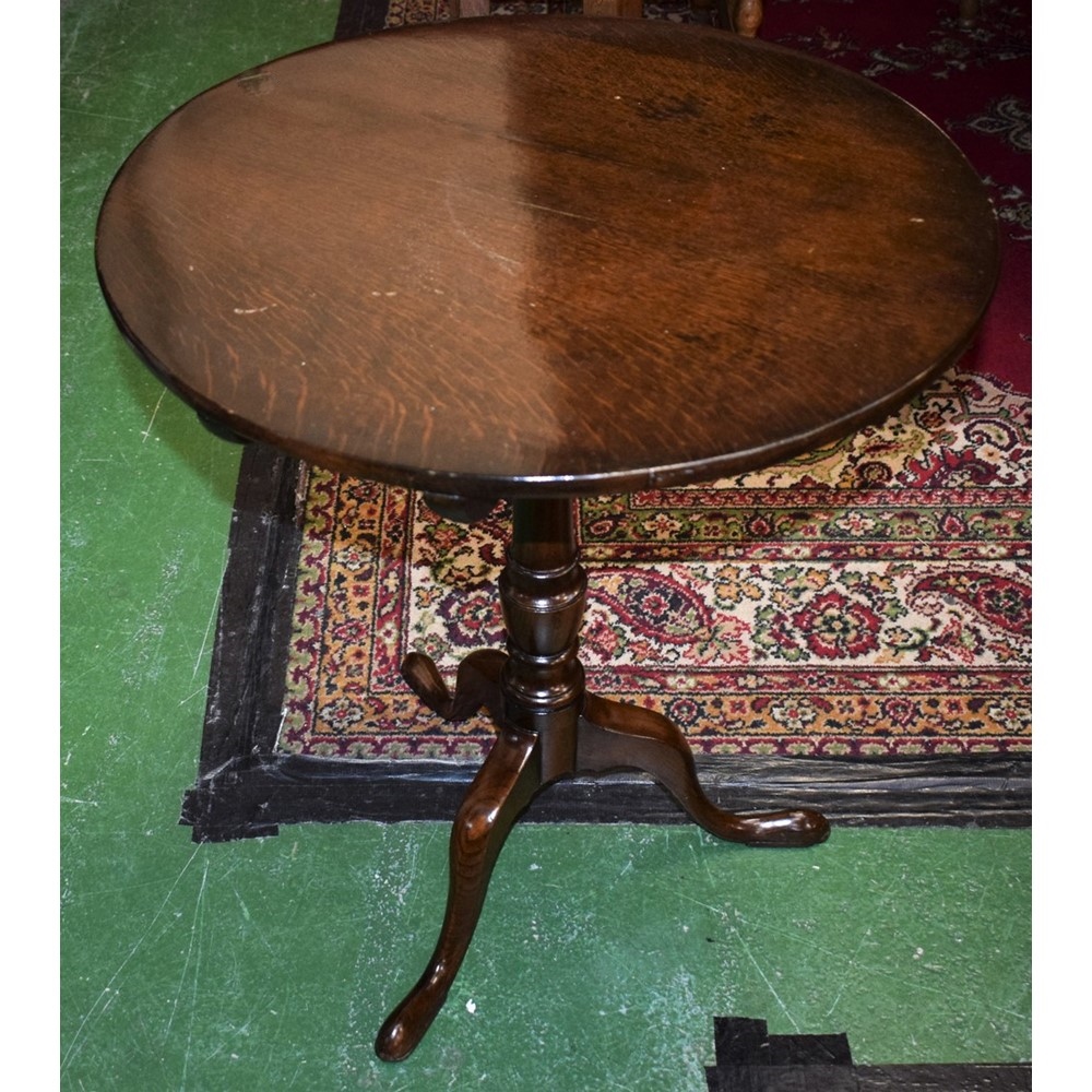 A George III style oak occasional table, circular tilting top, turned canon barrel column,