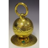 A Victorian brass inkwell, as a spherical weight, ring handle, spreading circular base, c.