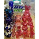 A cranberry glass lemonade jug; lemonade glasses; liqueur glasses etc.