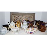 Various 19th century and later tea and coffee pots; a Chinese silk sleeve.