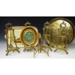 Four decorative gilt metal easels; an oval miniature gouache,