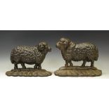 Two cast iron sheep door stops.