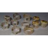 A quantity of silver and white metal napkin rings, including engine turned, engraved,