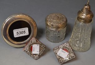 A silver circular photograph frame; a silver lidded hobnail cut cosmetic jar,