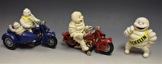 Advertising - a pair of reproduction cast metal Bibendum Michelin figures, on motorcycles; another,